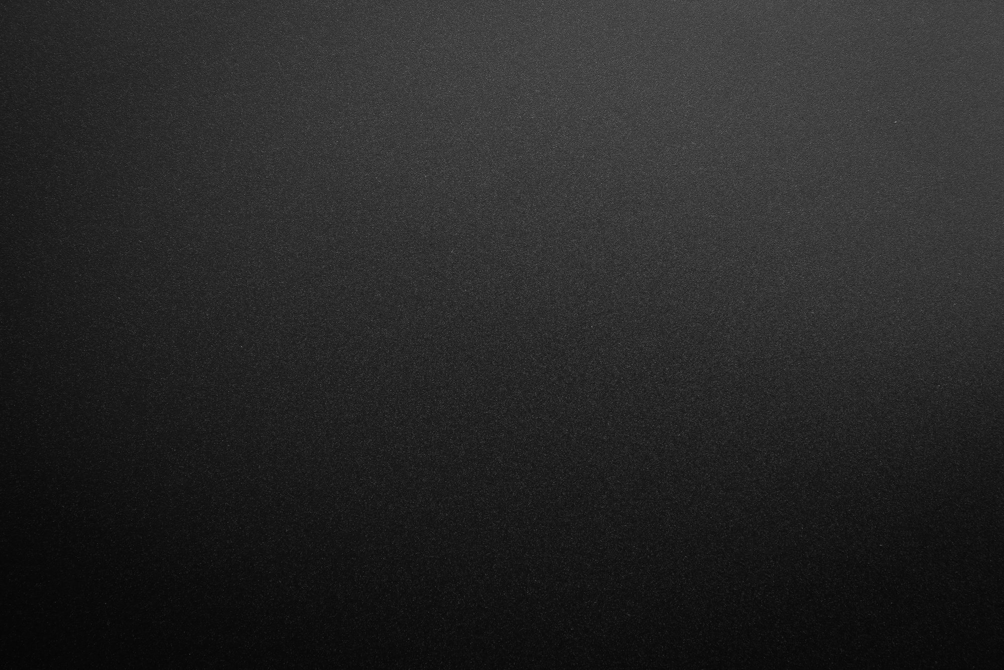 black paper texture or background with spotlight, dark wall backdrop wallpaper, dark tone.